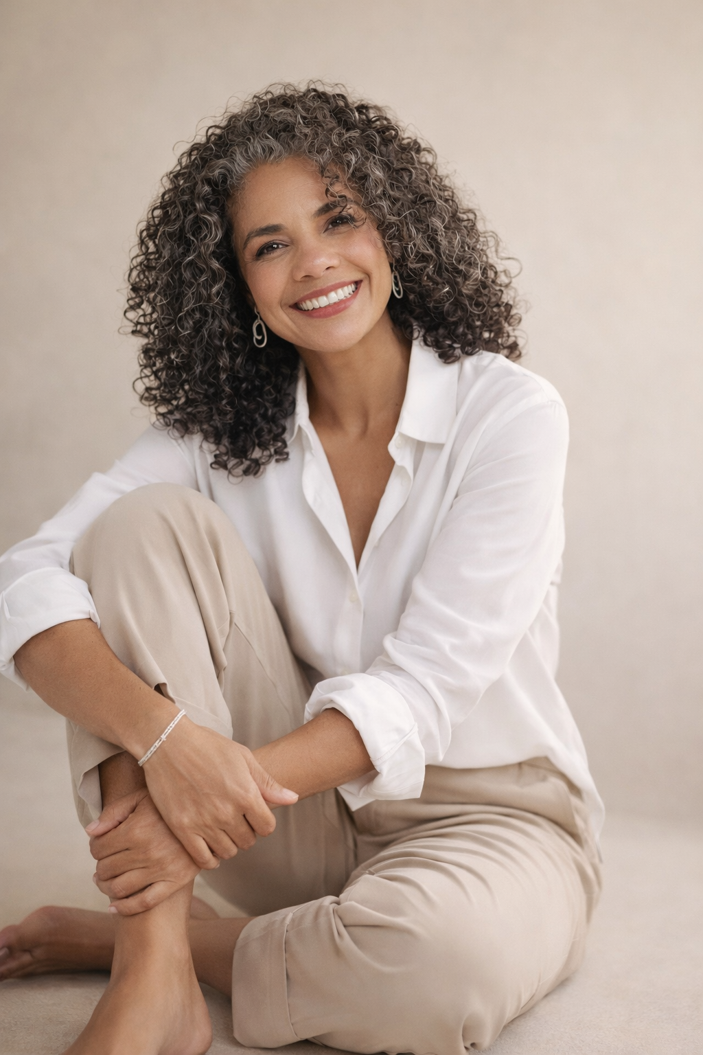 Angela Lira sorrindo, sentada, postura acolhedora